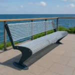 Metāla stienīšu sols uz promenādes pie jūras